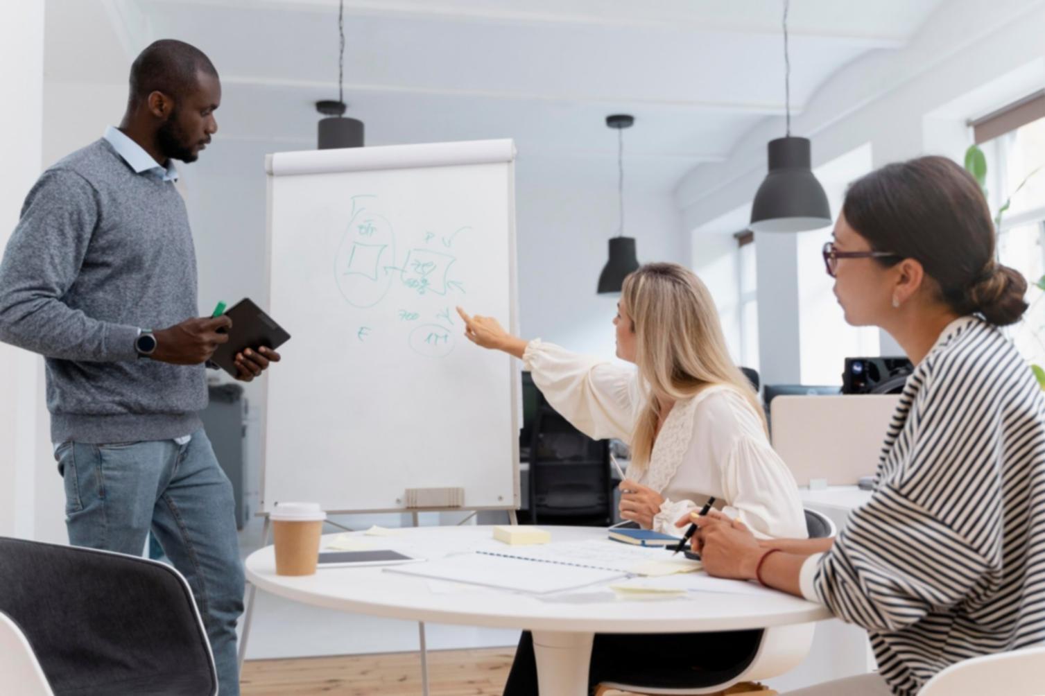 Students working on web development projects with code displayed on multiple screens
